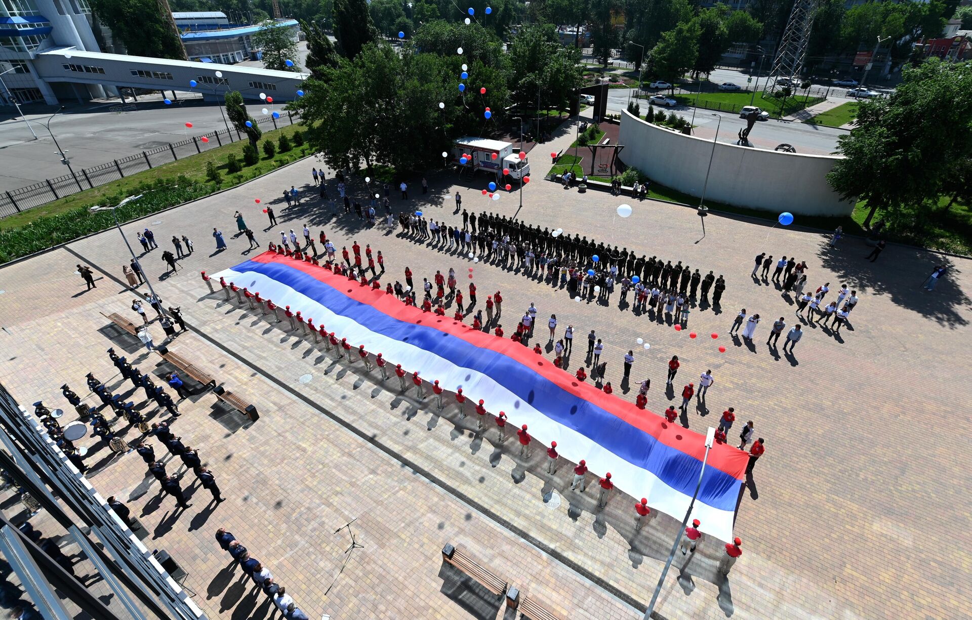 Военнослужащие Южного военного округа и волонтеры под музыку военного оркестра развернули 50-метровый государственный флаг России в честь празднования Дня России у здания Исторического парка Россия - моя история в Ростове - на - Дону. - РИА Новости, 1920, 19.08.2021