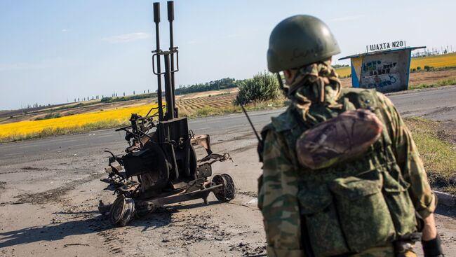 Боец народного ополчения возле сгоревшей зенитной установки ЗУ-232 украинской армии