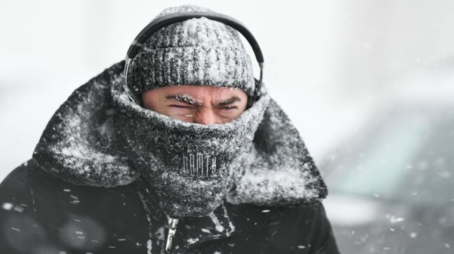 Прохожий во время снегопада в Москве