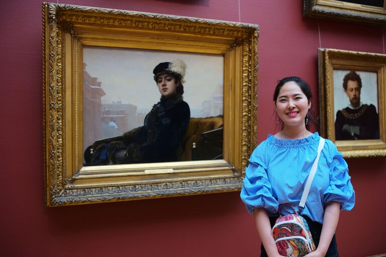 Девушка у картины Незнакомка русского художника Ивана Крамского в Третьяковской галерее в Москве